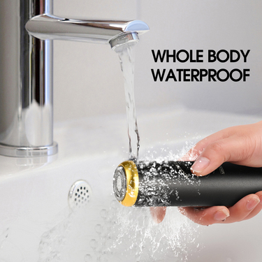 The Capsule beard shaver getting rinsed under a running tap